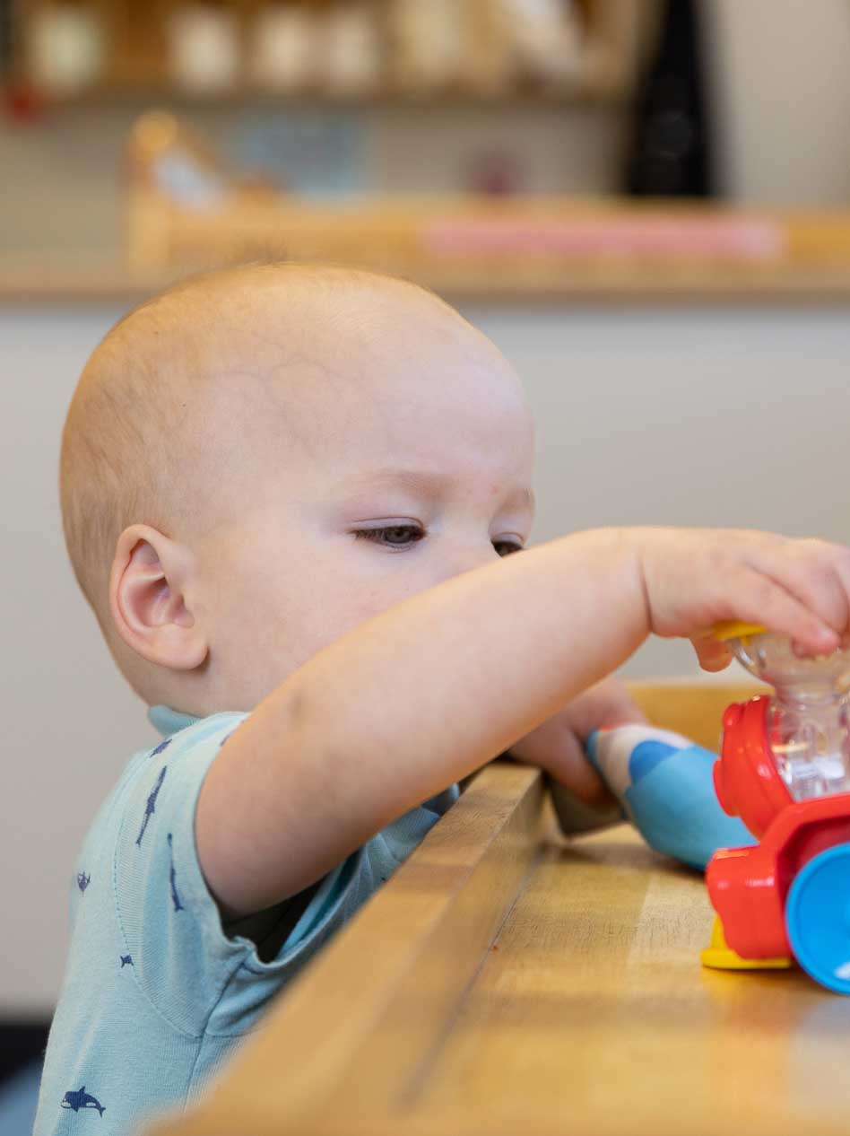 infant playing with toy