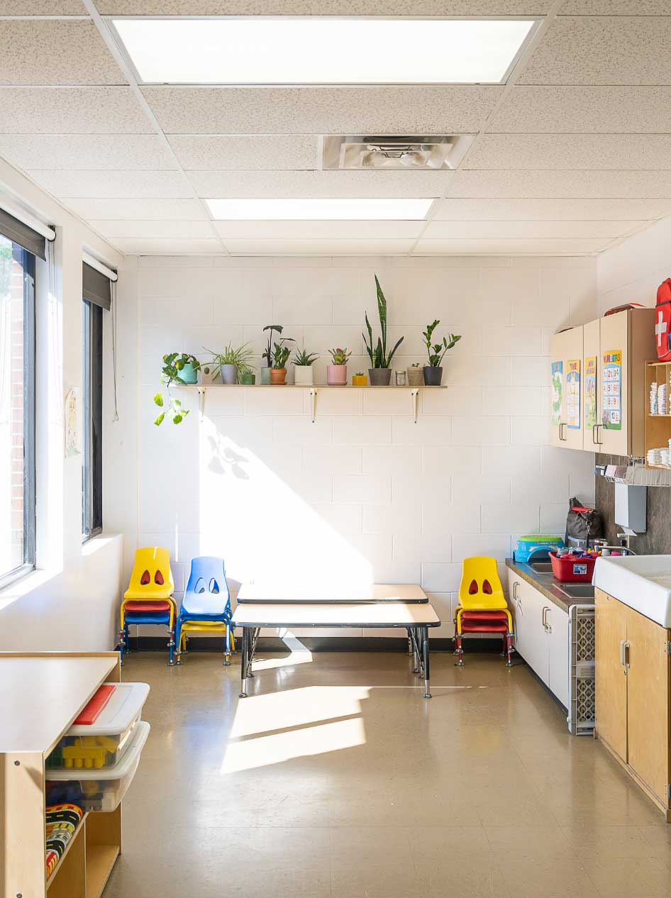 classroom with plants, toys and chairs